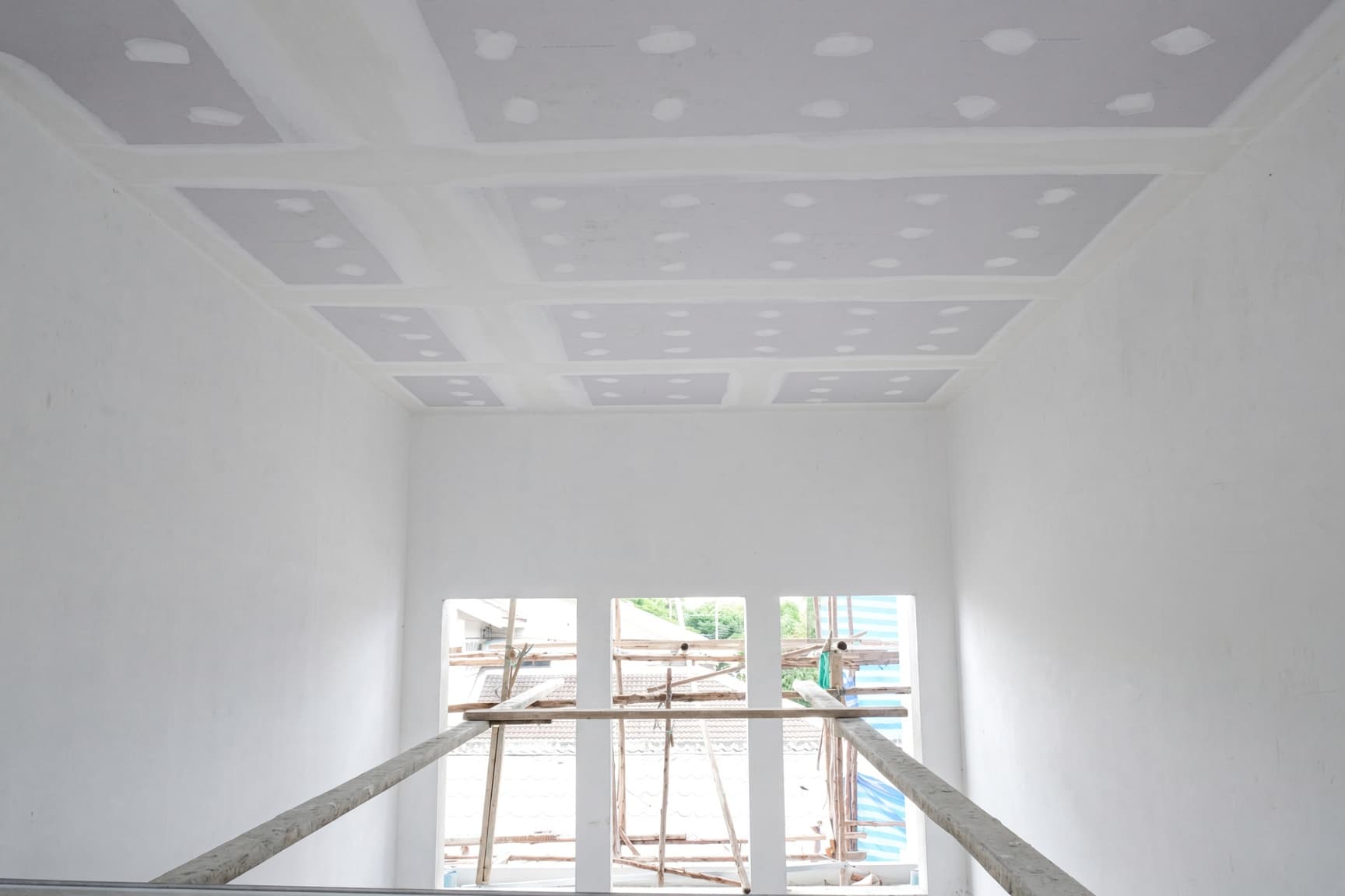 Ceiling in a Raleigh home skim coated to a smooth finish during resurfacing